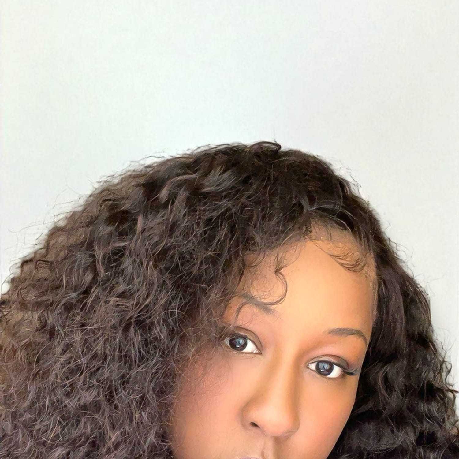 Portrait of Kiana	W, a professional stylist at Design 1 Salon & Spa, showcasing their expertise and style.
