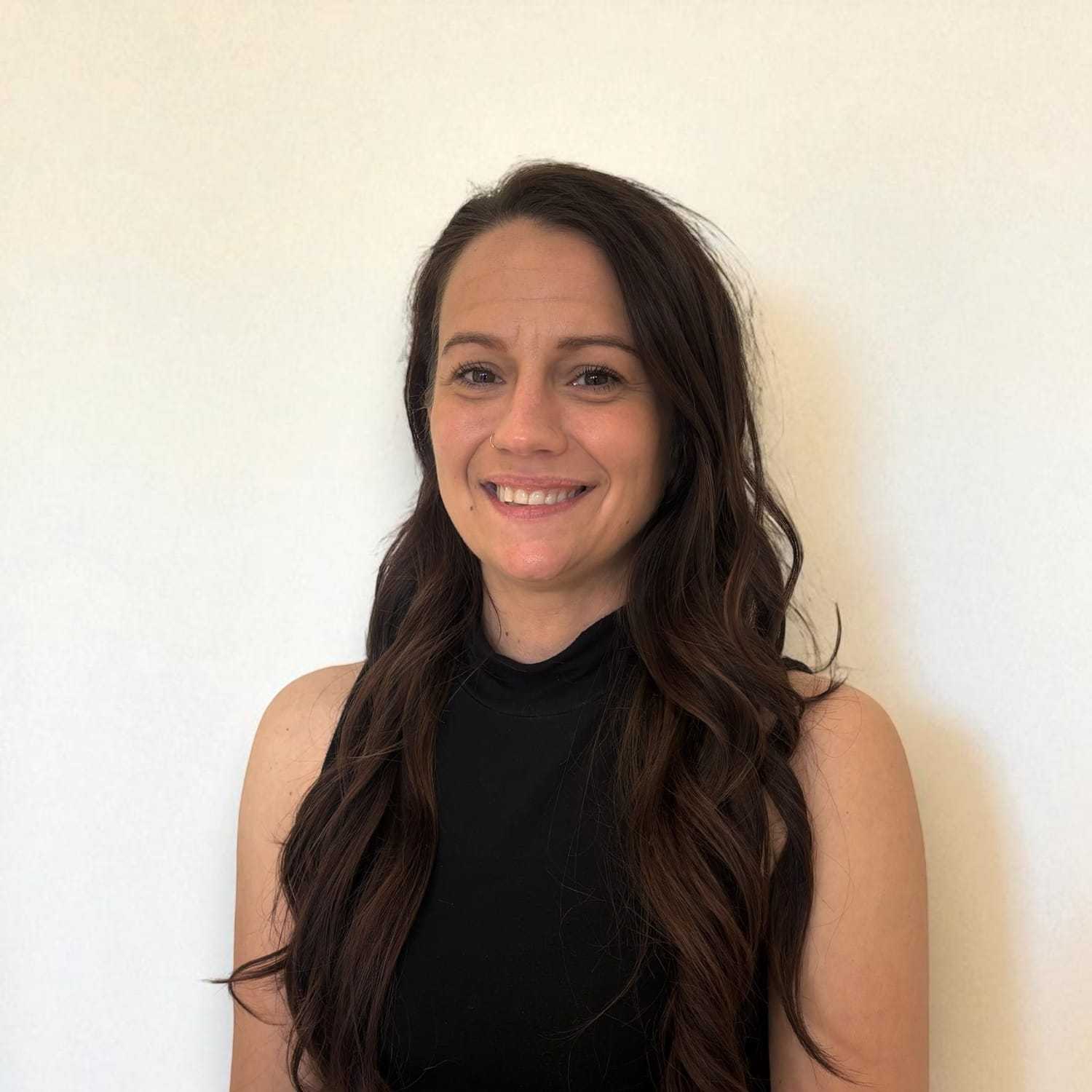 Portrait of Amber	B, a professional stylist at Design 1 Salon & Spa, showcasing their expertise and style.