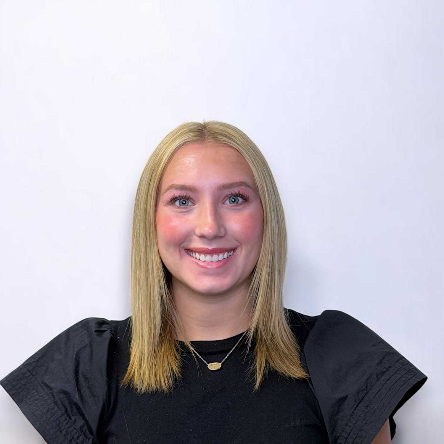 Portrait of Emma B, a professional stylist at Design 1 Salon & Spa, showcasing their expertise and style.