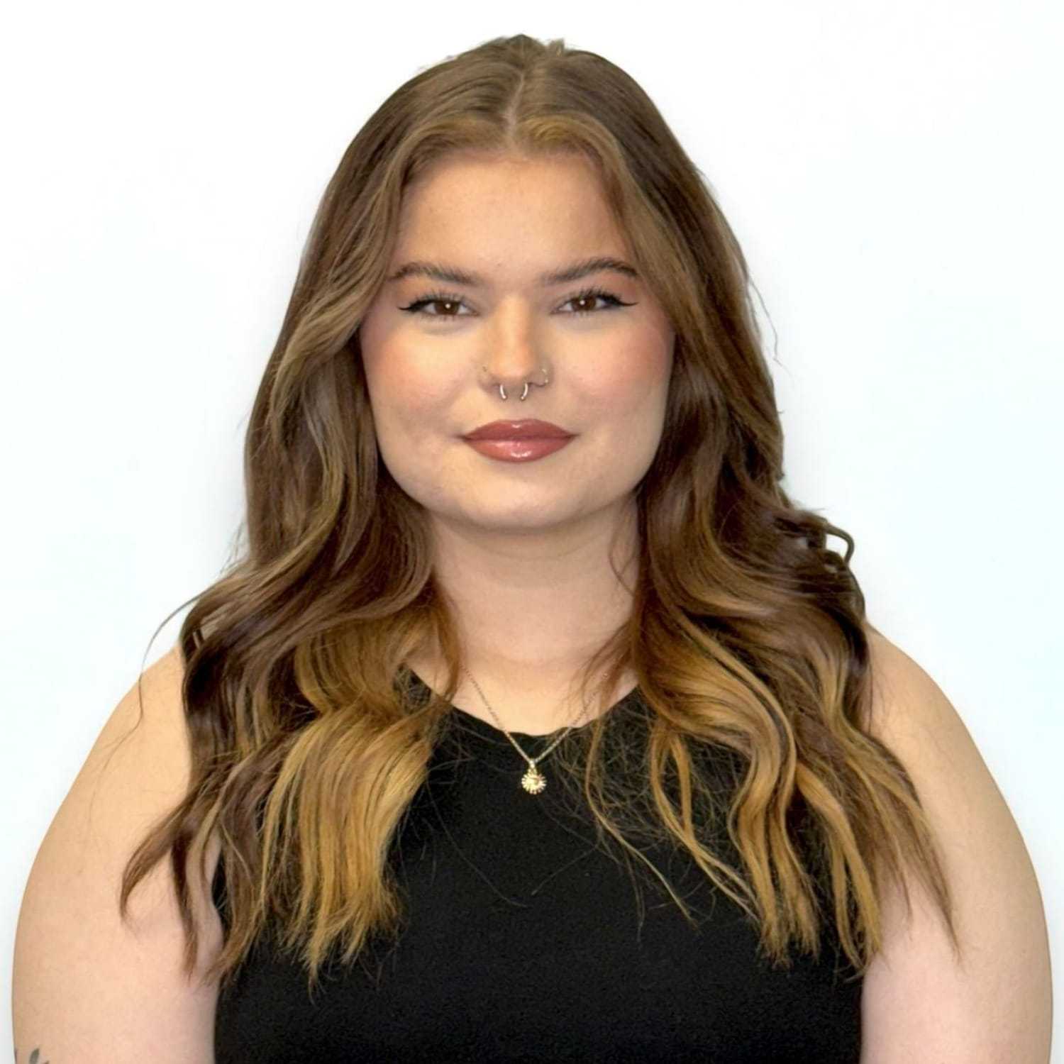 Portrait of Aubrey N, a professional stylist at Design 1 Salon & Spa, showcasing their expertise and style.