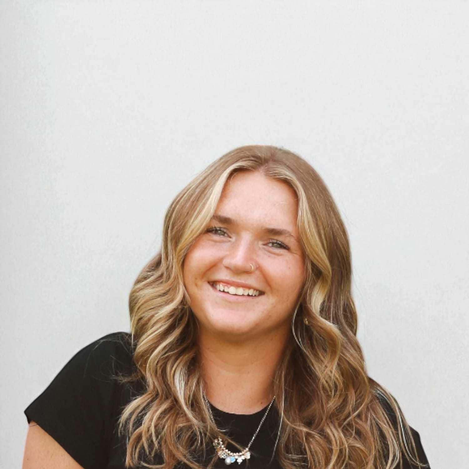Portrait of Annaliese	K, a professional stylist at Design 1 Salon & Spa, showcasing their expertise and style.
