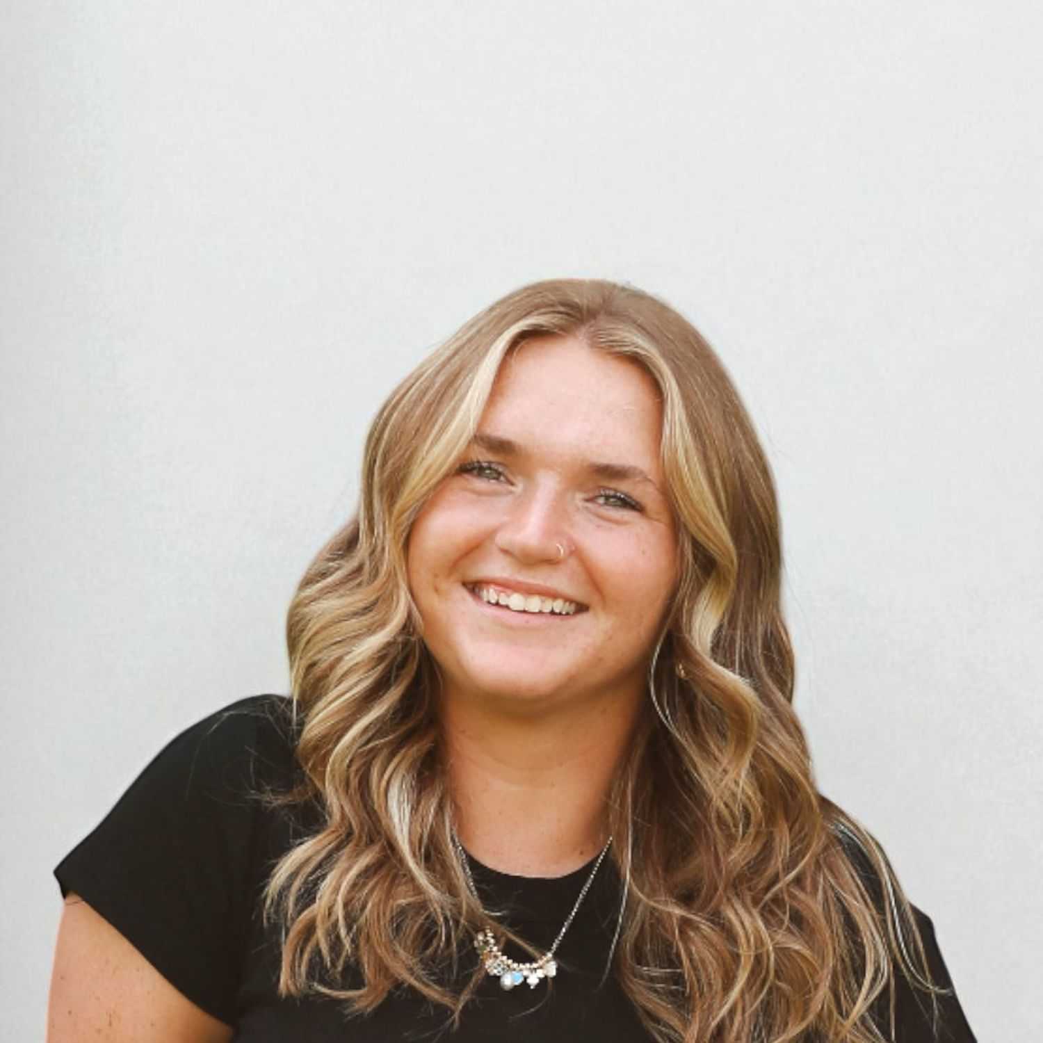 Portrait of Annaliese	K, a professional stylist at Design 1 Salon & Spa, showcasing their expertise and style.