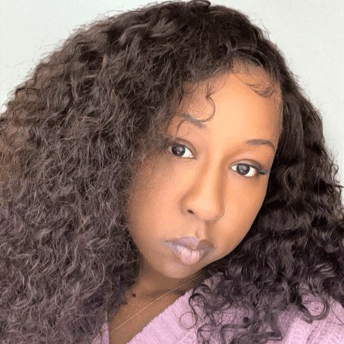Portrait of Kiana	W, a professional stylist at Design 1 Salon & Spa, showcasing their expertise and style.