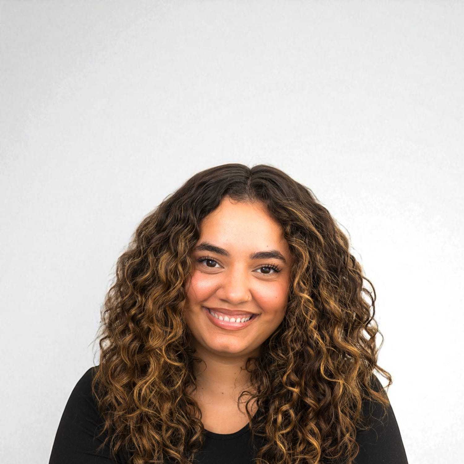 Portrait of Isabel	D, a professional stylist at Design 1 Salon & Spa, showcasing their expertise and style.