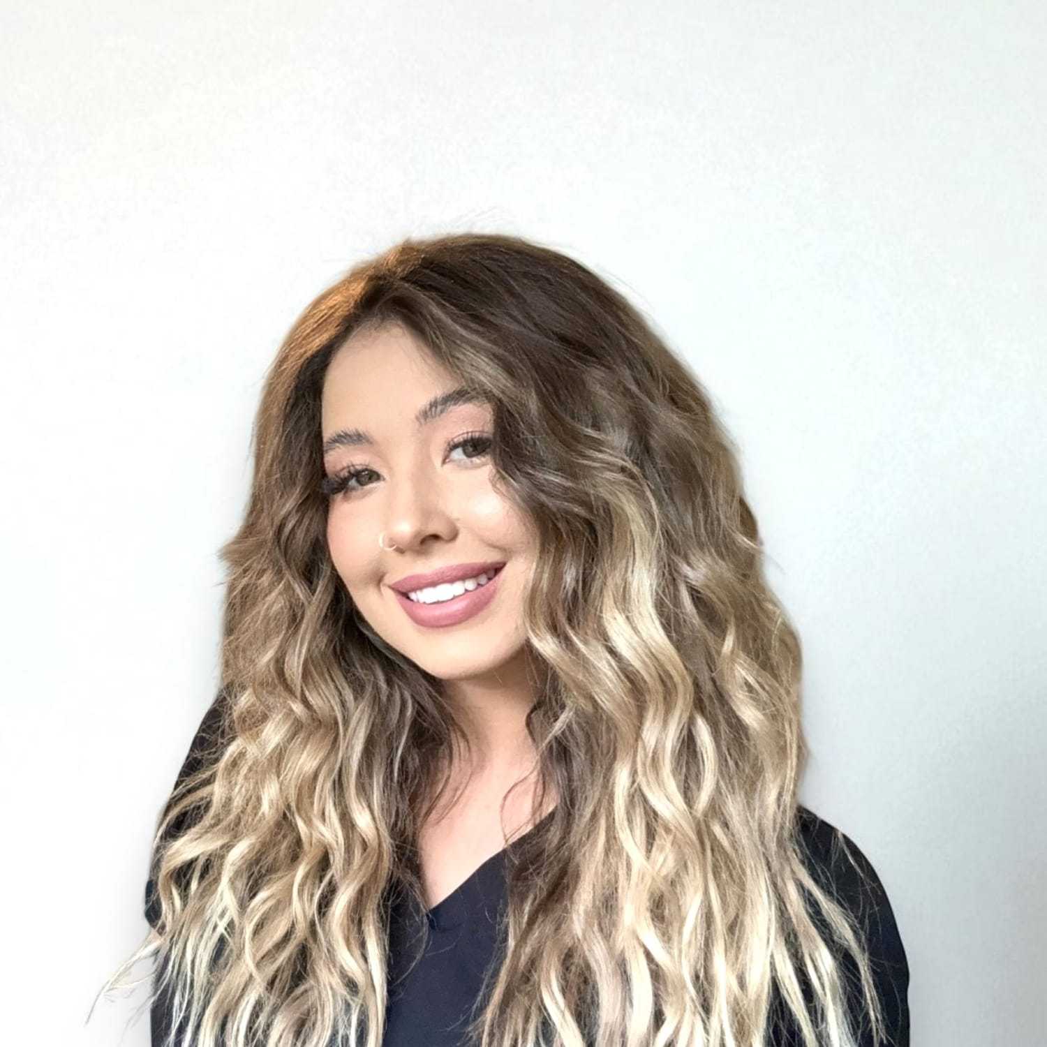 Portrait of Monet	V, a professional stylist at Design 1 Salon & Spa, showcasing their expertise and style.