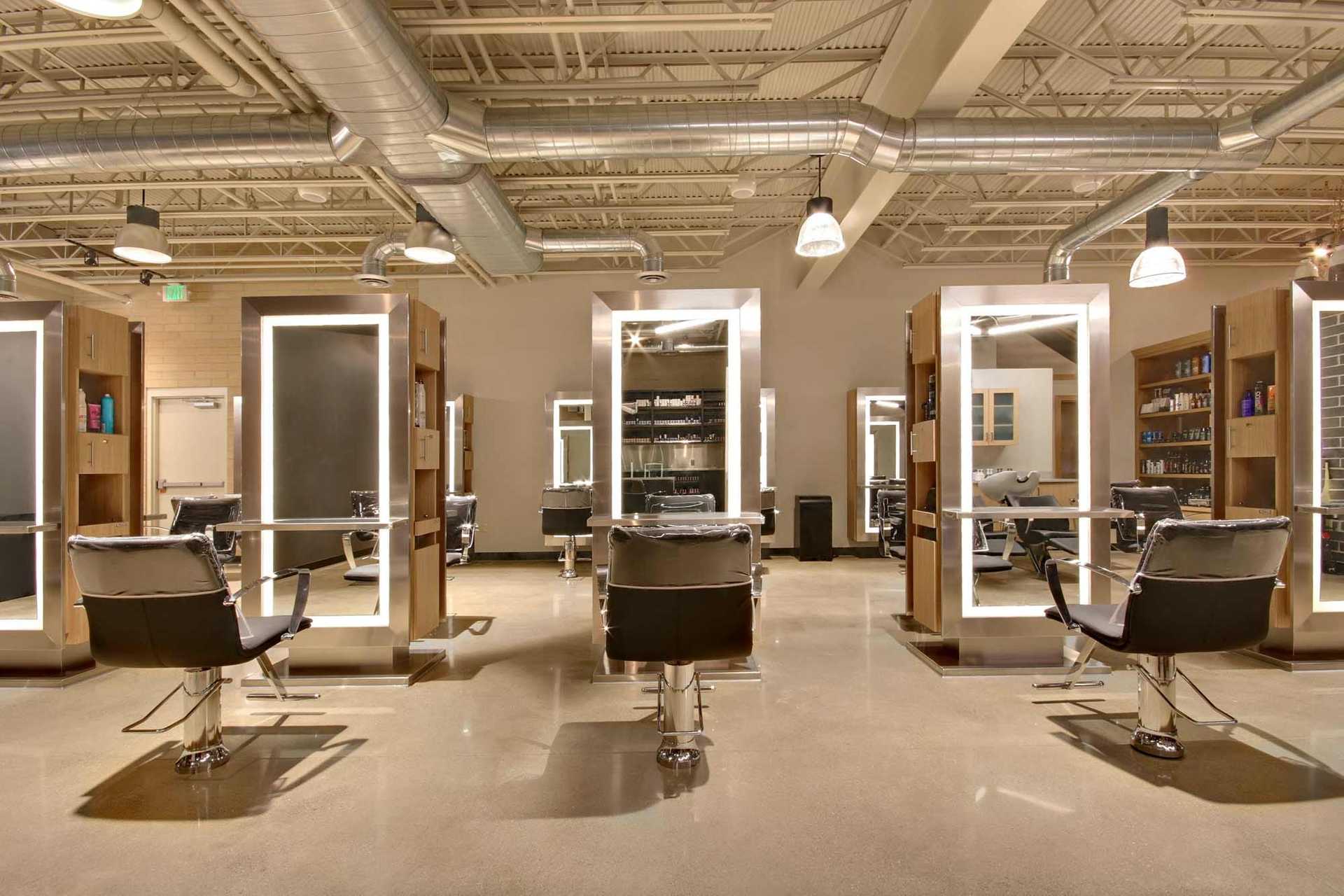 Modern hair salon interior with stylish chairs and mirrors, featuring chic industrial design.