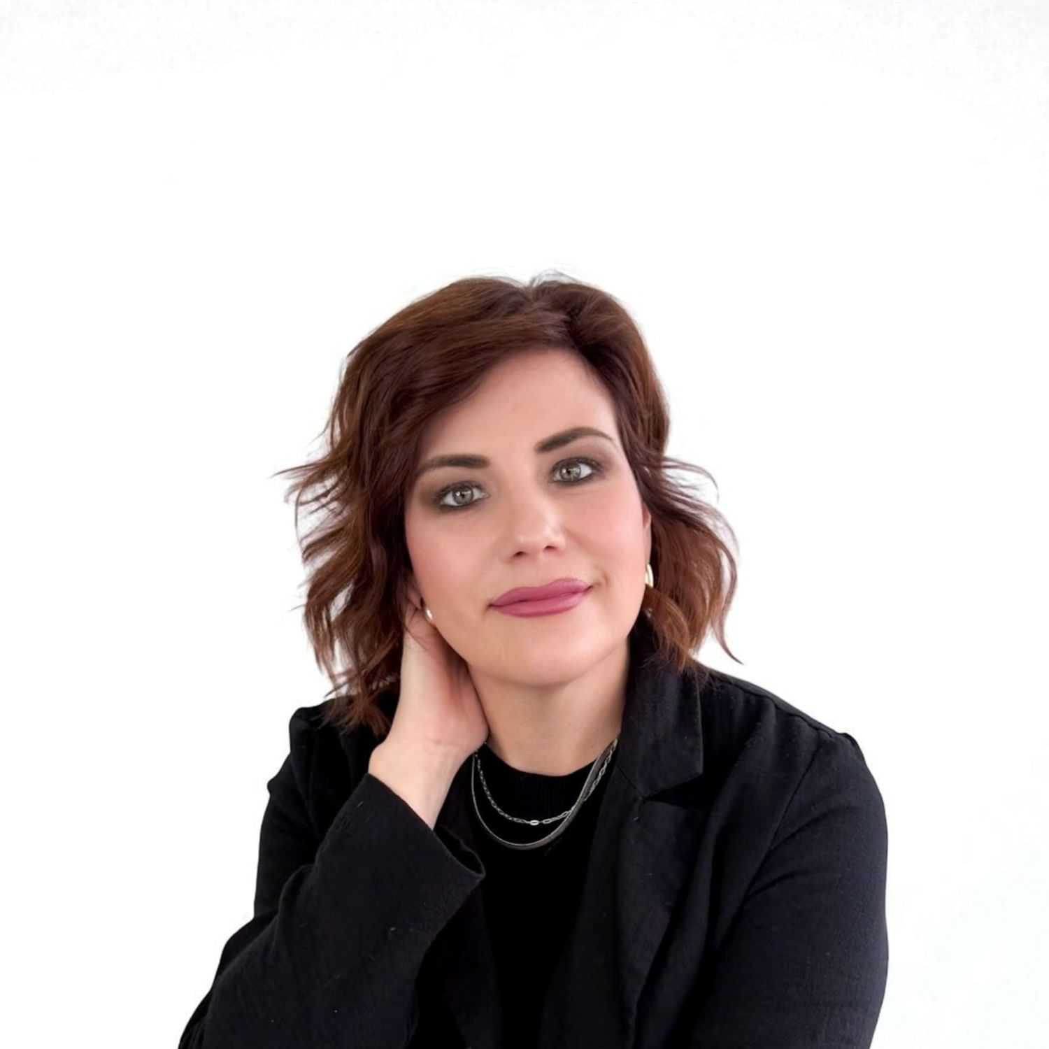 Portrait of Raye R, a professional stylist at Design 1 Salon & Spa, showcasing their expertise and style.