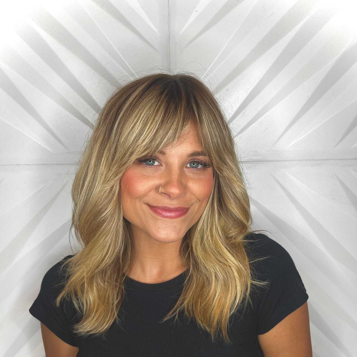Portrait of Kass D, a professional stylist at Design 1 Salon & Spa, showcasing their expertise and style.