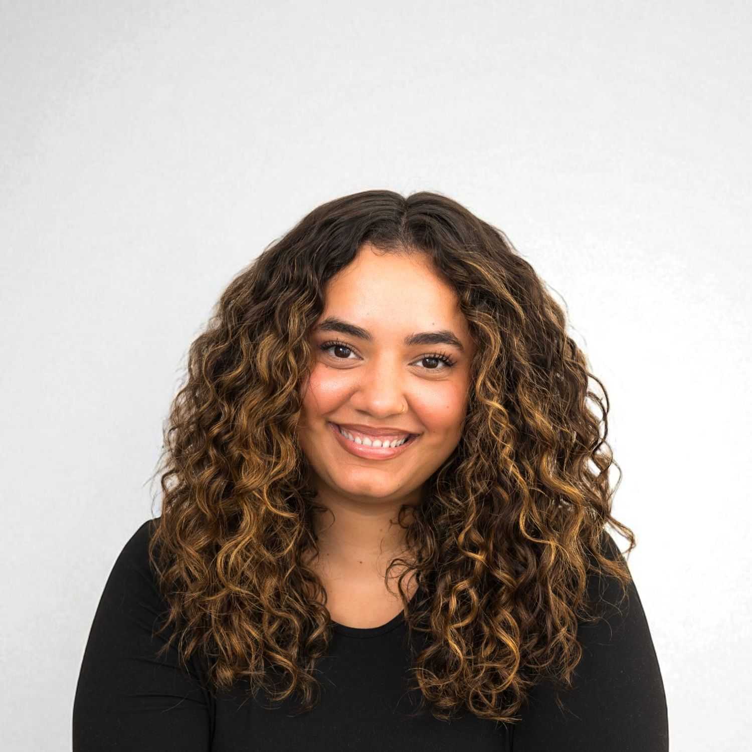 Portrait of Isabel	D, a professional stylist at Design 1 Salon & Spa, showcasing their expertise and style.