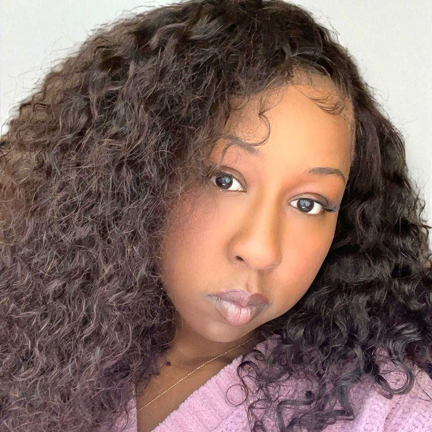 Portrait of Kiana	W, a professional stylist at Design 1 Salon & Spa, showcasing their expertise and style.