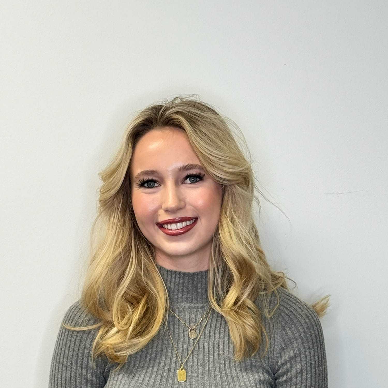 Portrait of Regan H, a professional stylist at Design 1 Salon & Spa, showcasing their expertise and style.