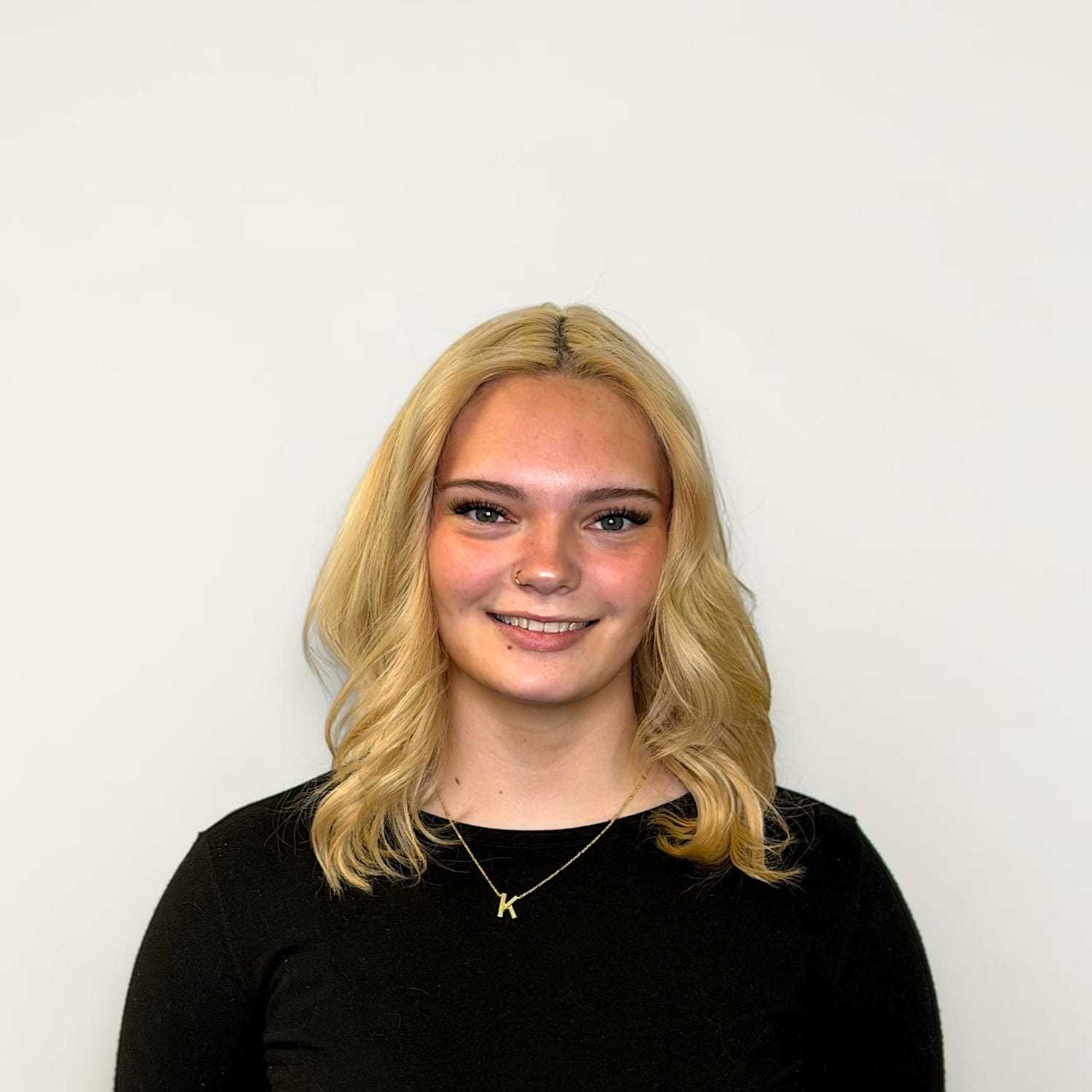 Portrait of Kenzie W, a professional stylist at Design 1 Salon & Spa, showcasing their expertise and style.