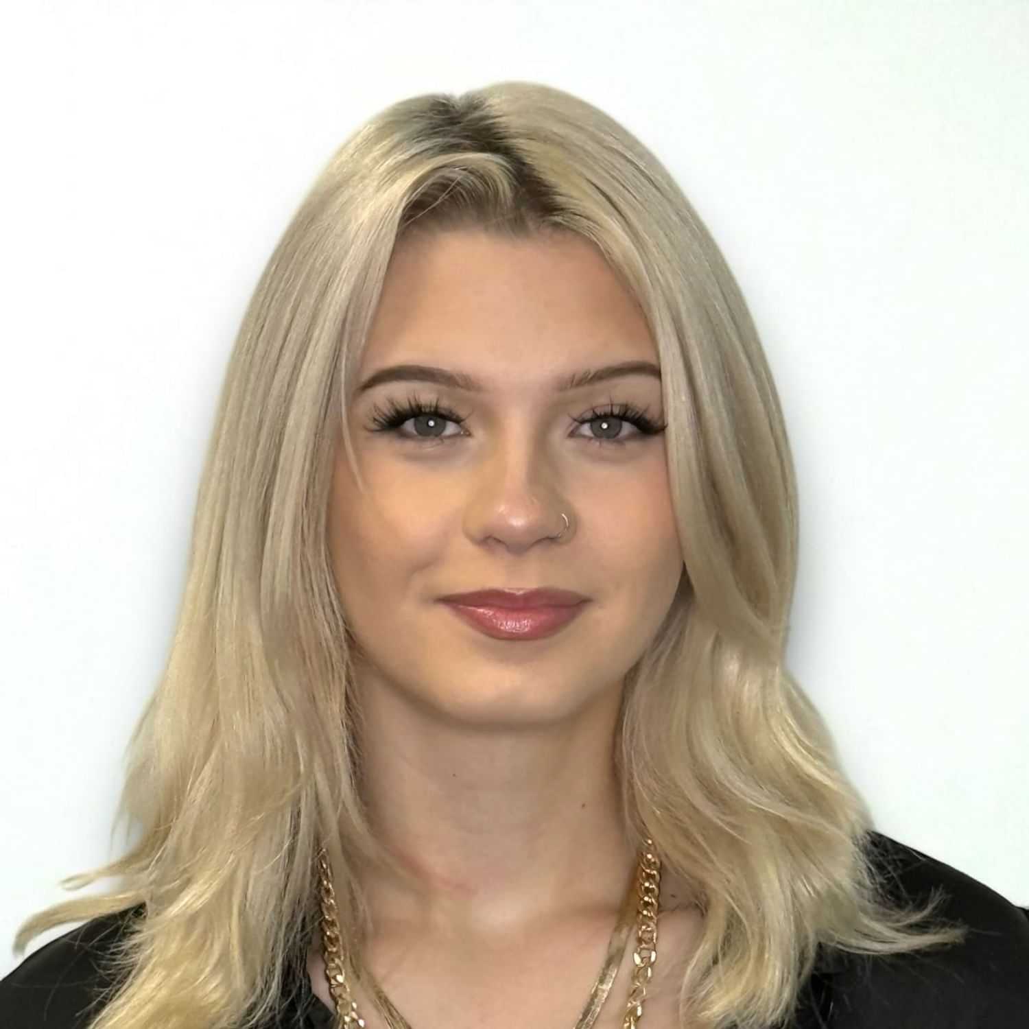 Portrait of Dallis H, a professional stylist at Design 1 Salon & Spa, showcasing their expertise and style.