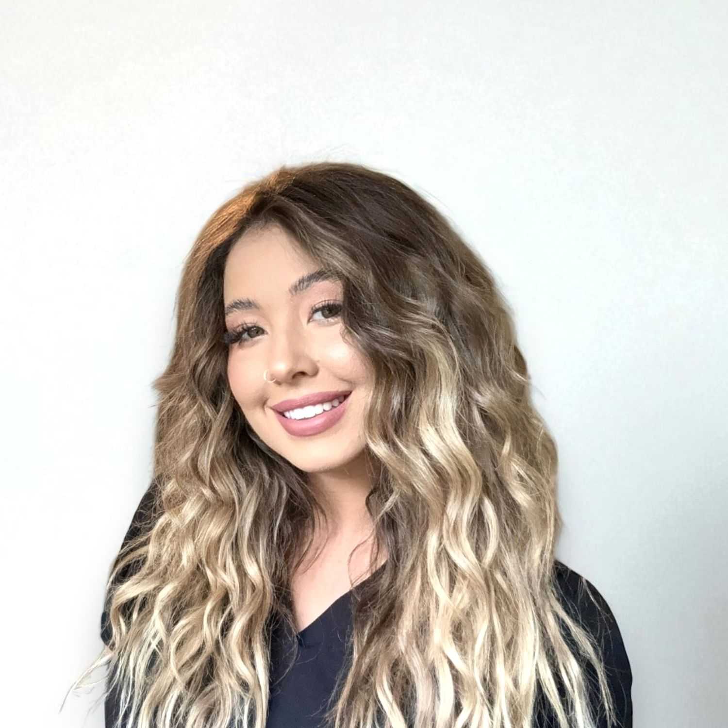 Portrait of Monet	V, a professional stylist at Design 1 Salon & Spa, showcasing their expertise and style.